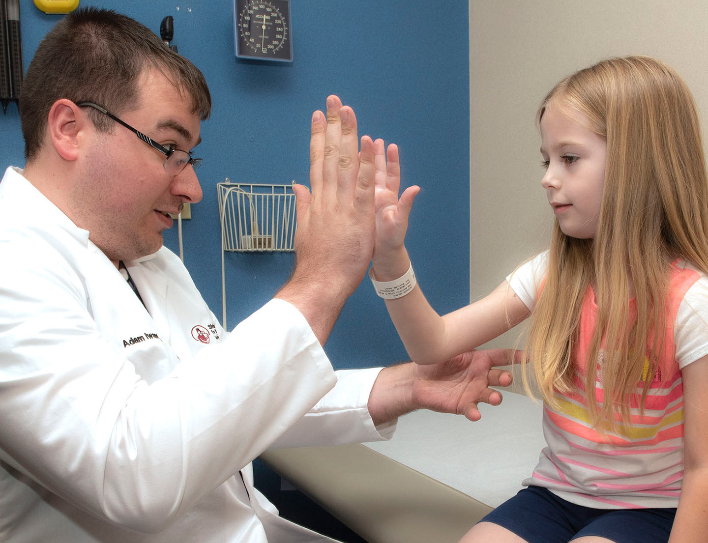 patient and physician share a high five